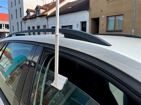 Obrázek: plastový držák na autovlaječku a jeho instalace na okno vozidla
