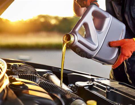 pouring engine oil into filler cap