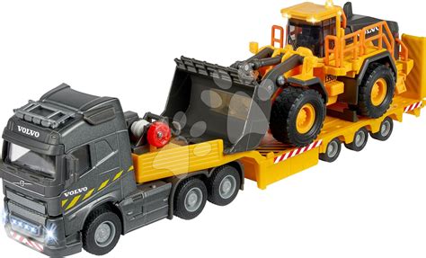 Kombinace Volvo FMX s Volvo bagrem a nakladačem na staveništi